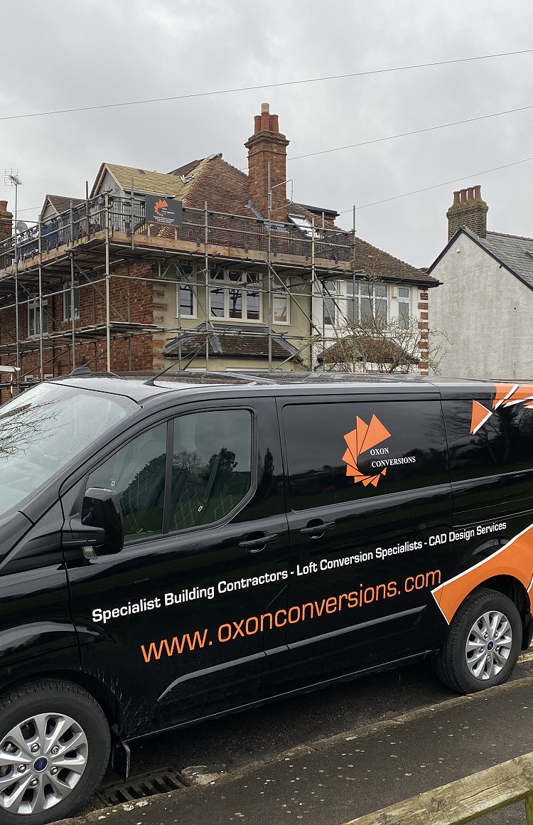 An Oxon Conversions van in front of a house